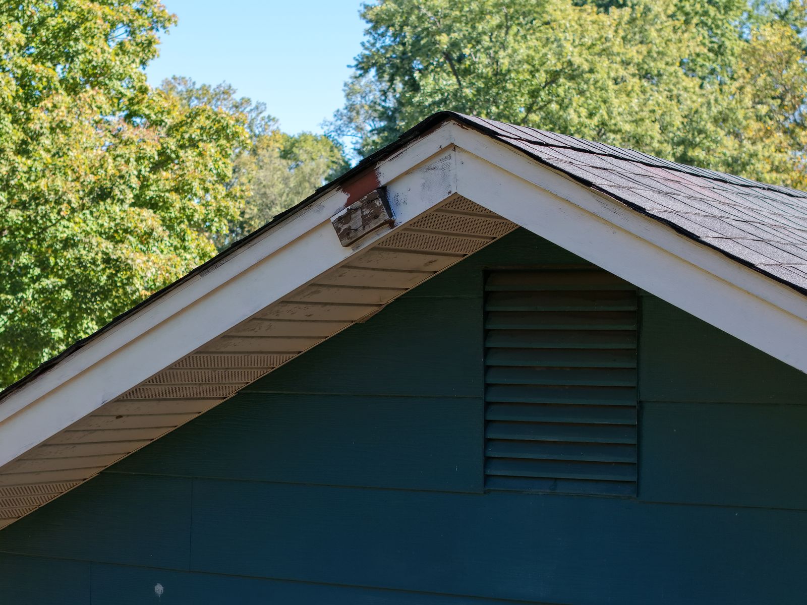 Close-up drone view of a home's gable peak and trim